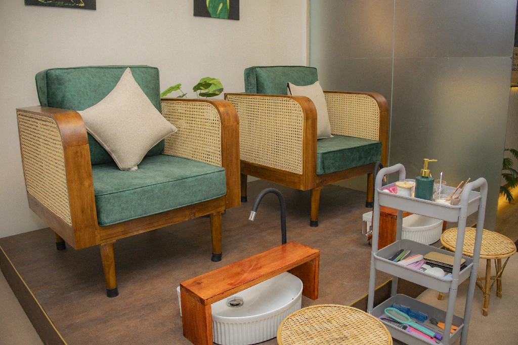 Green cane-back chairs and pedicure stations in the Nirvana Lounge pedicure area