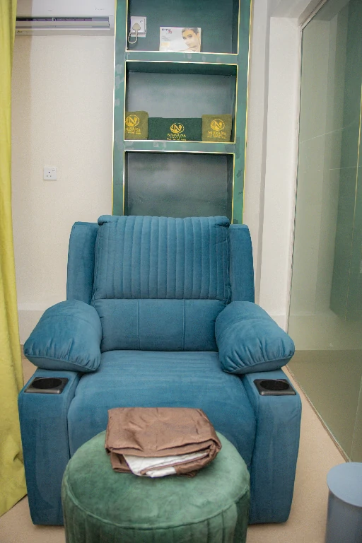 Teal reclining chair and green ottoman set up for a foot massage